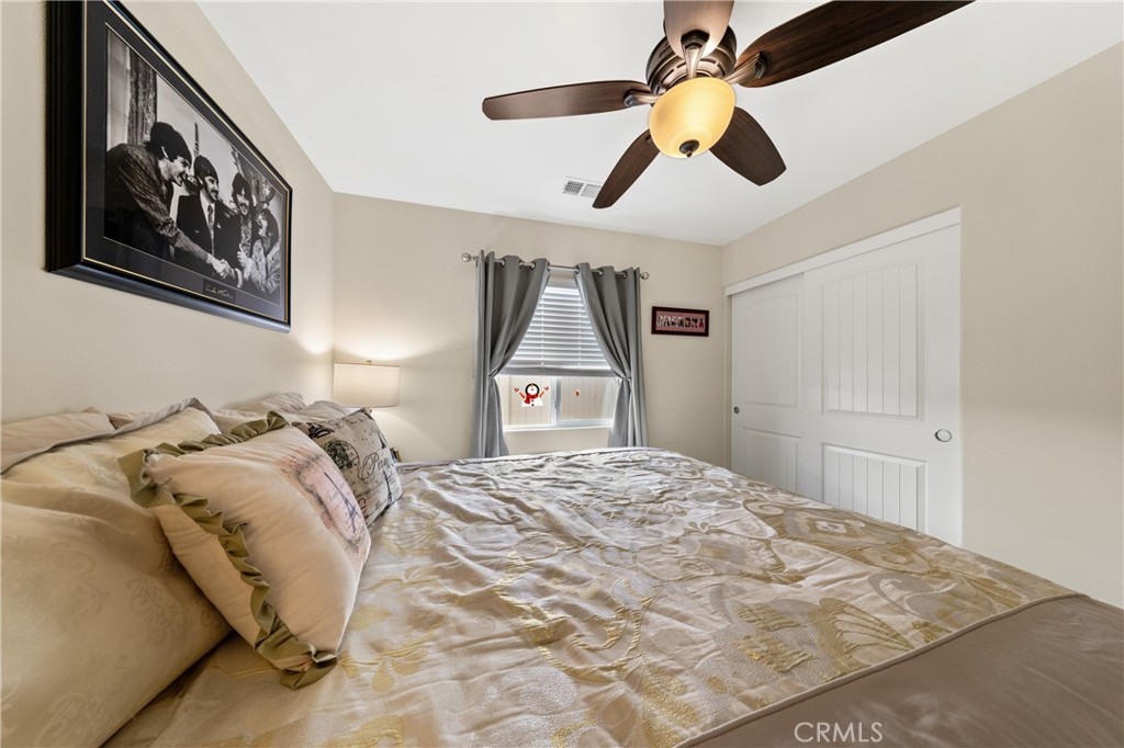 826 Avenida Del Rio San Jacinto, CA 92582 - Photo 18 of 36 a bedroom with a bed and a painting on the wall