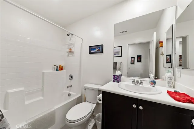 a bathroom with a sink a toilet tub and shower