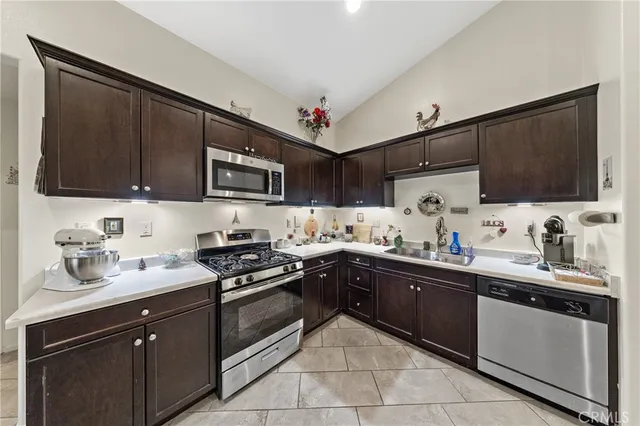 a kitchen with a sink stove and microwave