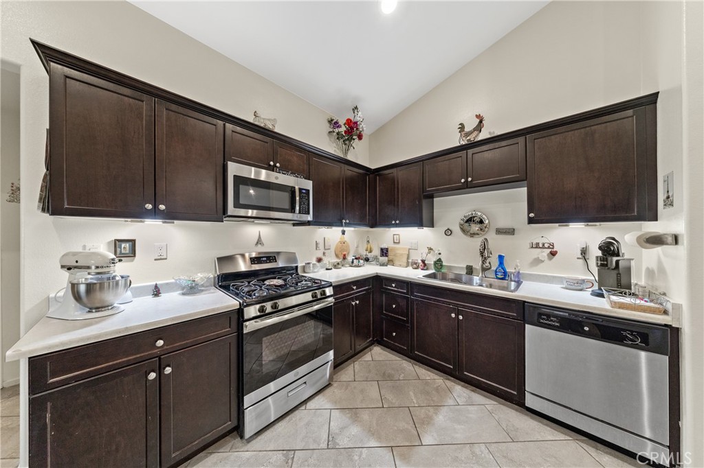 826 Avenida Del Rio San Jacinto, CA 92582 - Photo 2 of 36 a kitchen with a sink stove and microwave