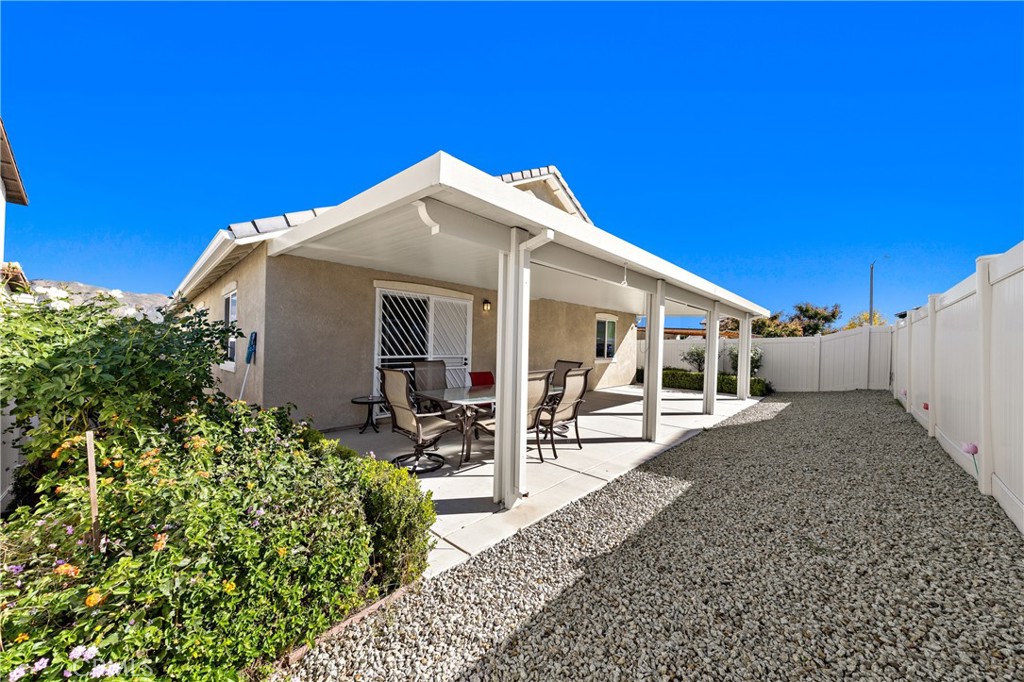 826 Avenida Del Rio San Jacinto, CA 92582 - Photo 25 of 36 a patio with table and chairs and potted plants