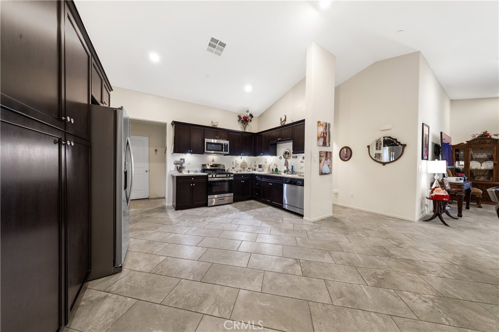 826 Avenida Del Rio San Jacinto, CA 92582 - Photo 6 of 36 a kitchen with stainless steel appliances granite countertop a refrigerator and a sink