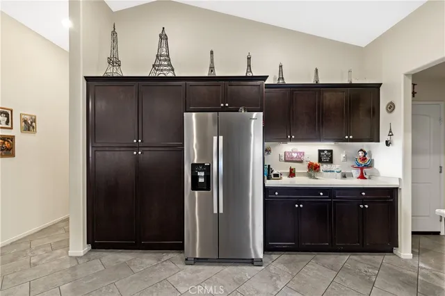 a kitchen with a refrigerator and a sink
