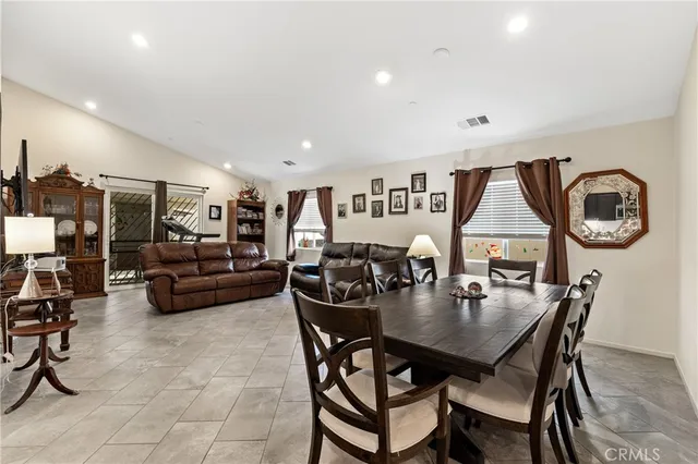 a dining room with furniture and a large window
