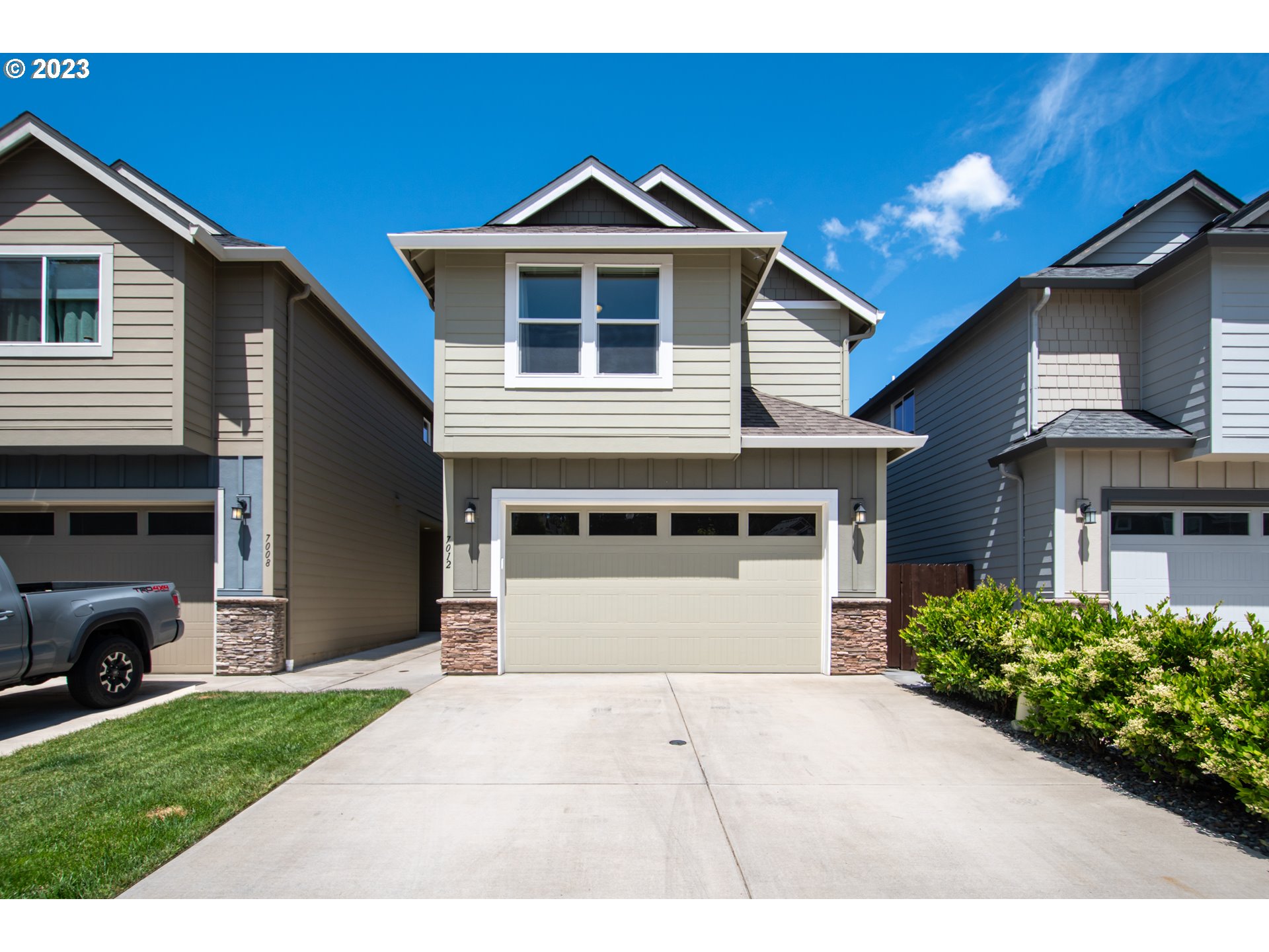 7012 South 11th Street Ridgefield, WA 98642 - Photo 1 of 28 a front view of a house with a yard and garage