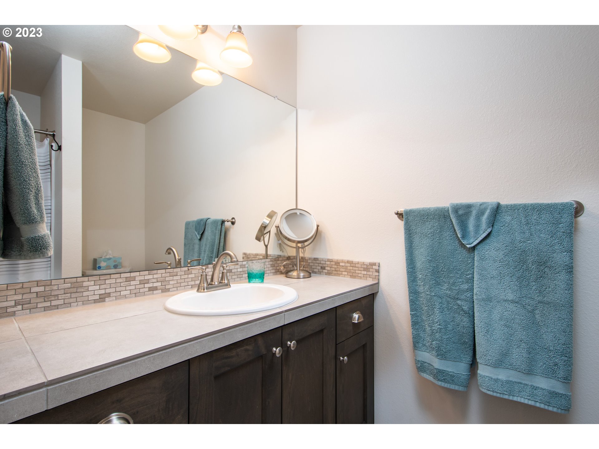 7012 South 11th Street Ridgefield, WA 98642 - Photo 19 of 28 a bathroom with a sink vanity granite and a mirror