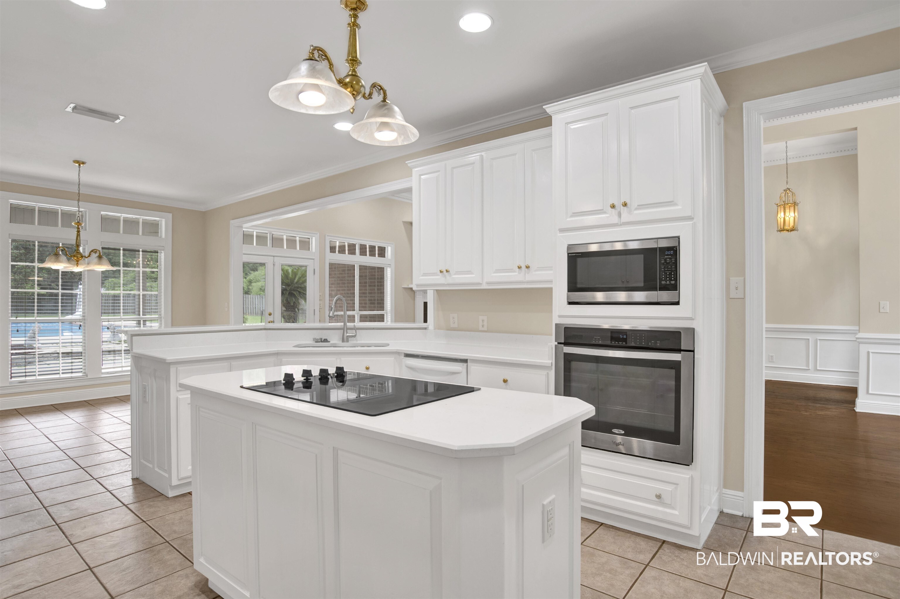 8847 Dawes Lake Road South Mobile, AL 36619 - Photo 12 of 47 Bright kitchen featuring white cabinetry, a built-in oven and microwave, a cooktop island, and tile flooring