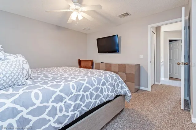 a bedroom with a bed and a flat screen tv