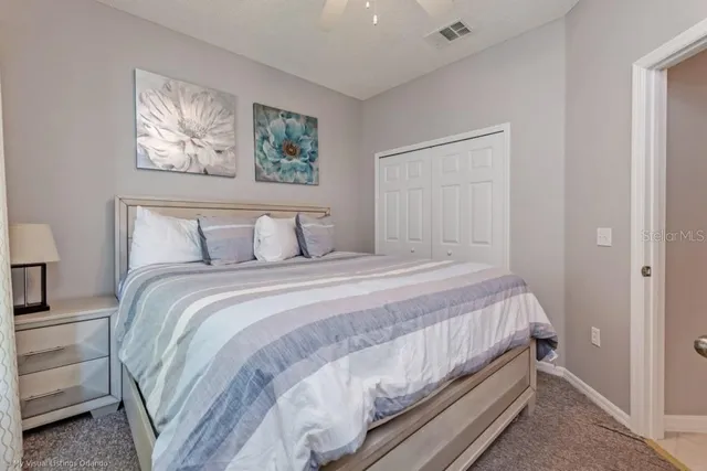 a bedroom with a bed and a painting on the wall