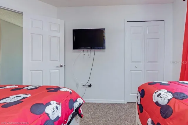 a bedroom with a bed and a flat screen tv