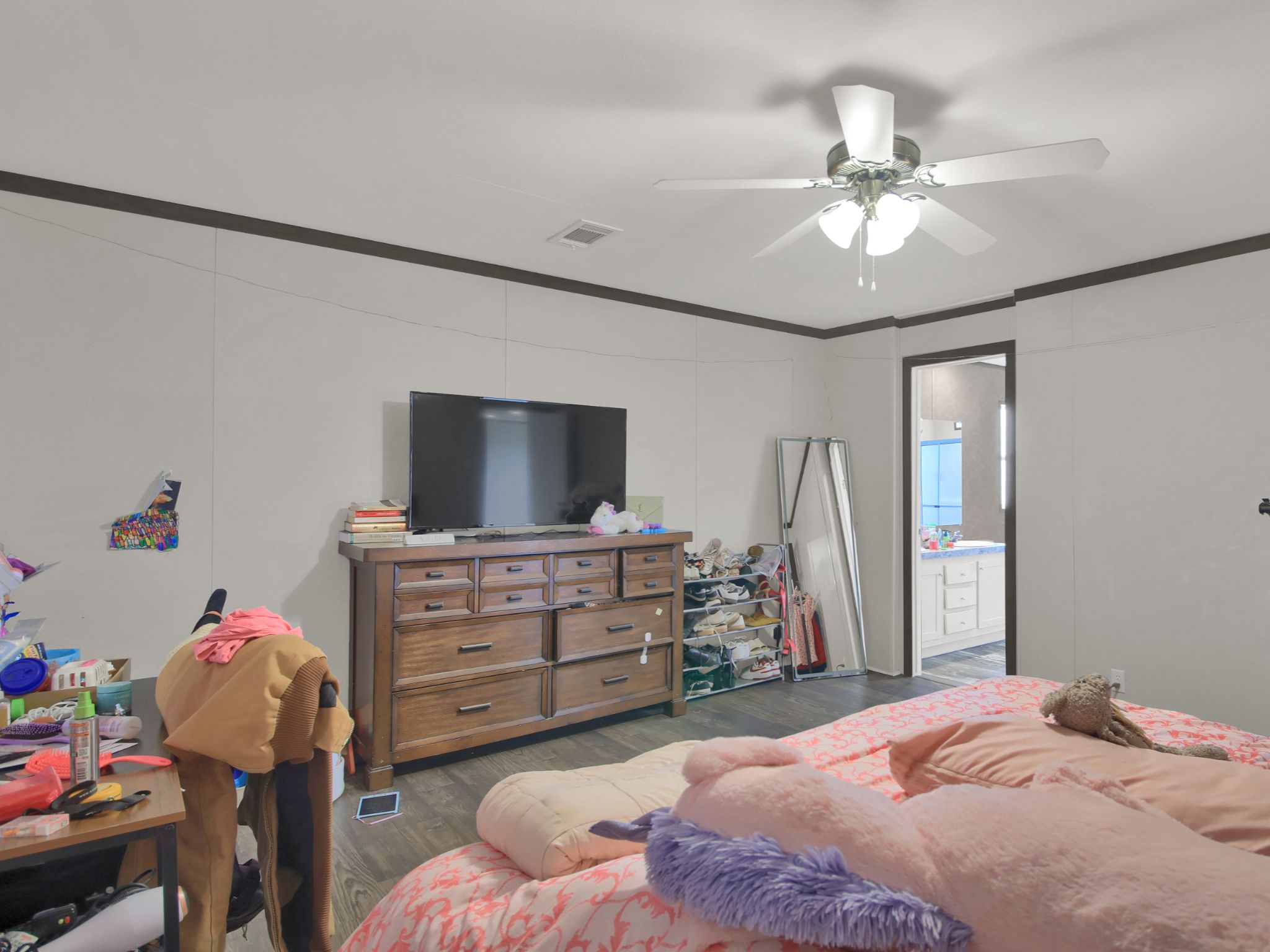 271 Alma Lane Kyle, TX 78640 - Photo 17 of 25 a bedroom with a bed and a chandelier