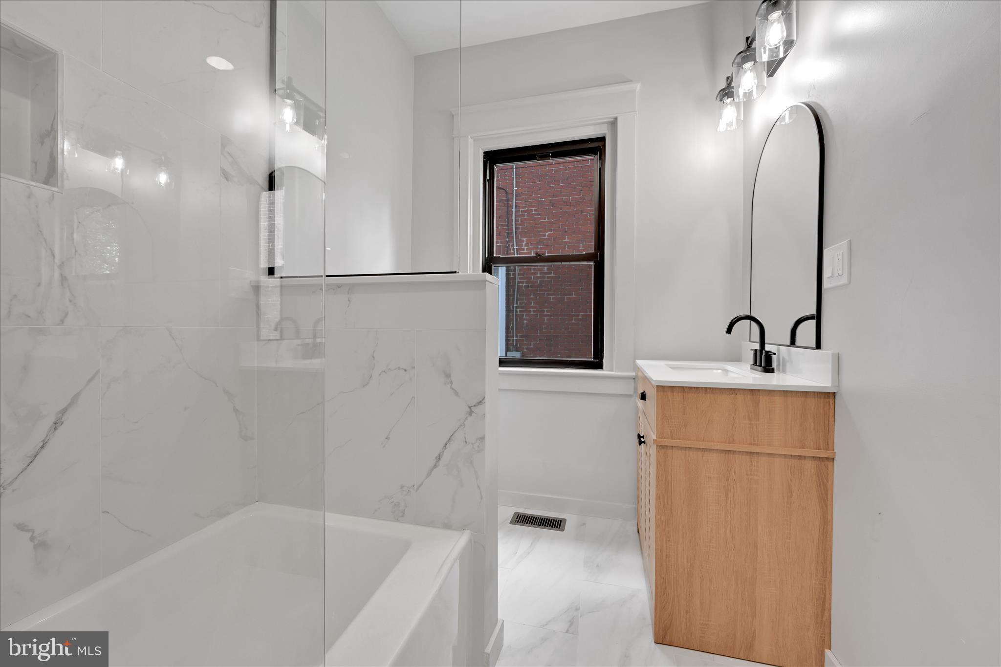 149 Tulpehocken Avenue Reading, PA 19611 - Photo 18 of 44 a bathroom with a sink a mirror and a bathtub