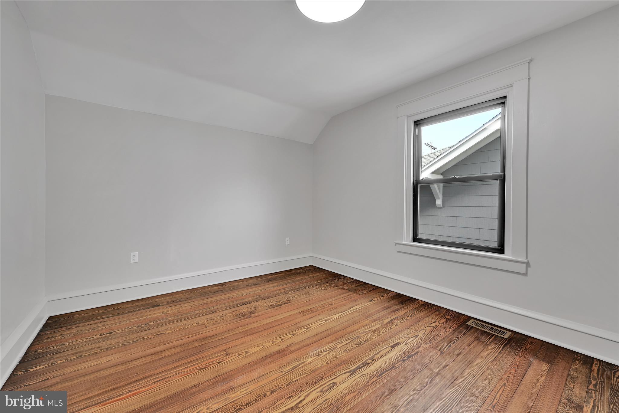 149 Tulpehocken Avenue Reading, PA 19611 - Photo 22 of 44 a view of an empty room with wooden floor and a window