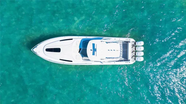 a view of a backyard with lawn chairs and large trees