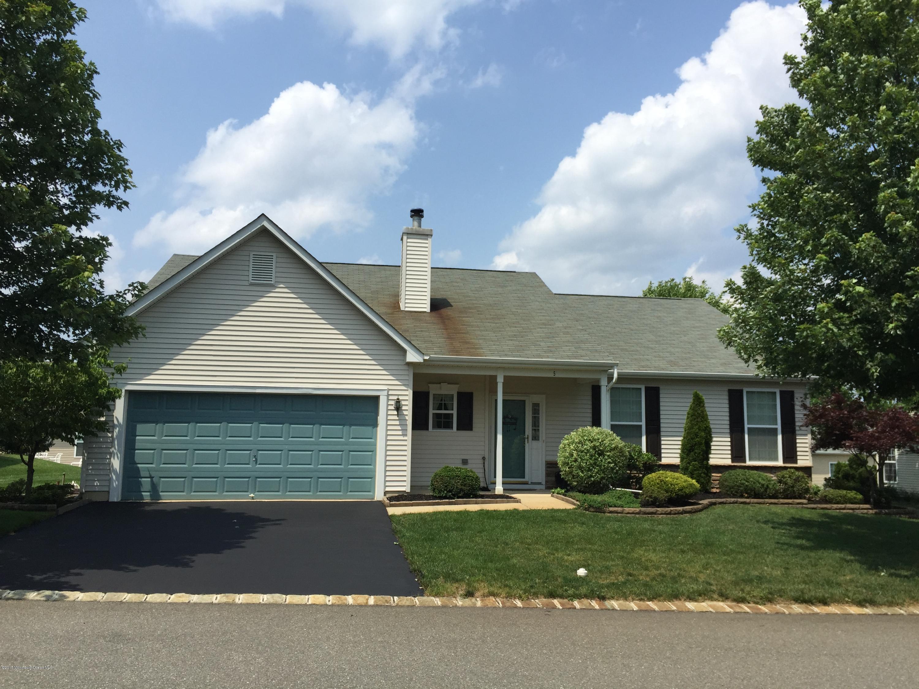 5 Springdale Road Whiting, NJ 08759 - Photo 3 of 11 a front view of a house with a yard and garage