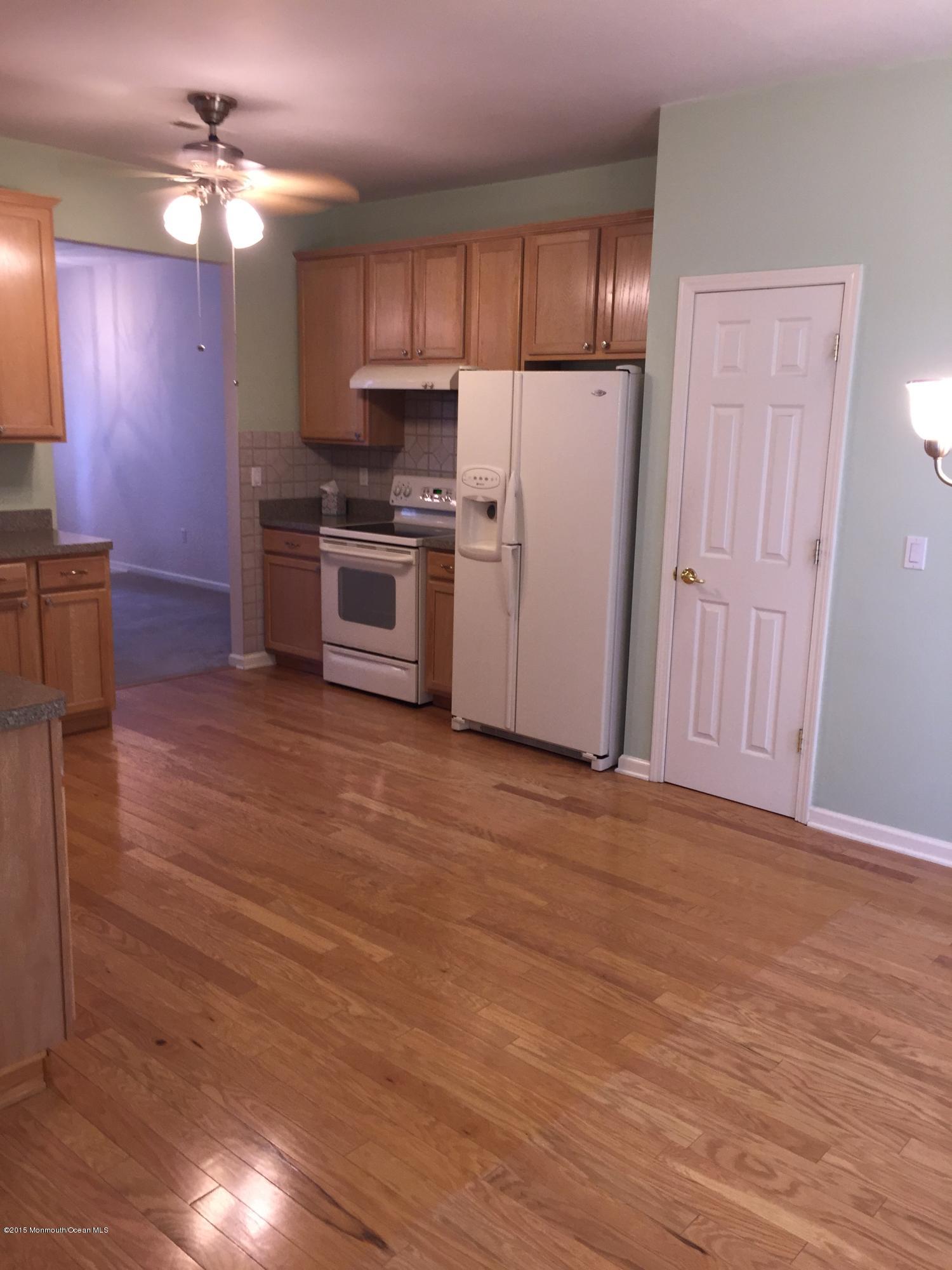 5 Springdale Road Whiting, NJ 08759 - Photo 7 of 11 a kitchen with granite countertop a refrigerator a stove a sink and dishwasher with wooden floor