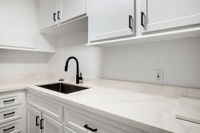 a bed with a large bed and a large mirror next to a window