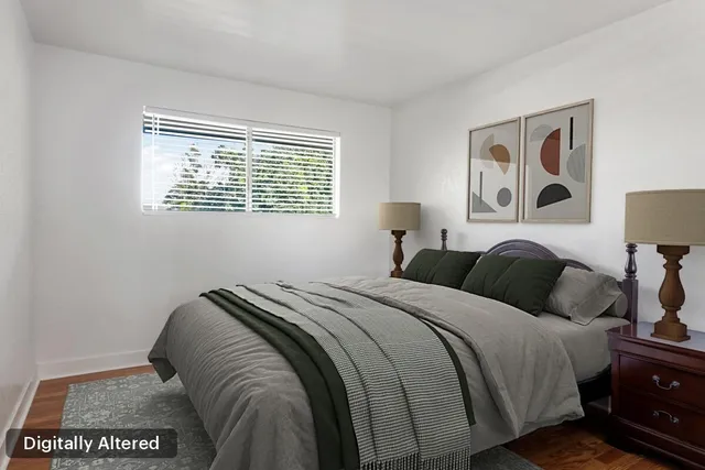 a bed sitting in a bedroom next to a window