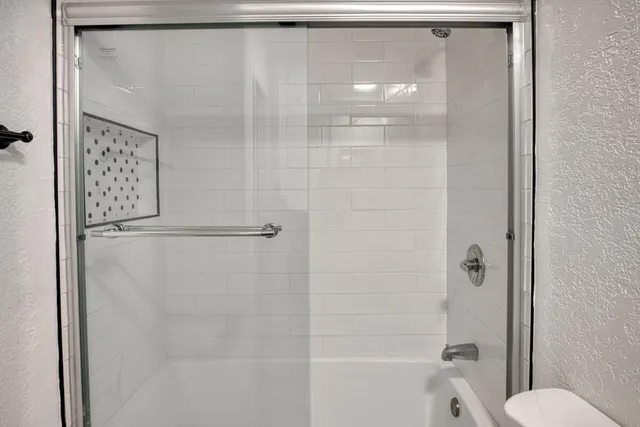 a view of a park with a bench and trees around