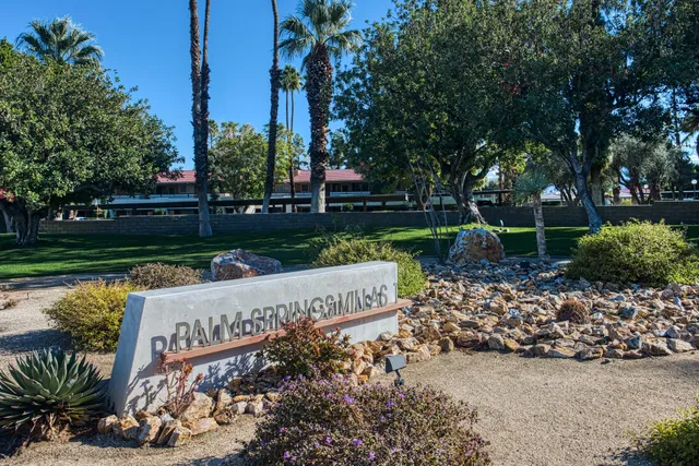a view of a house with a swimming pool and a chairs in patio