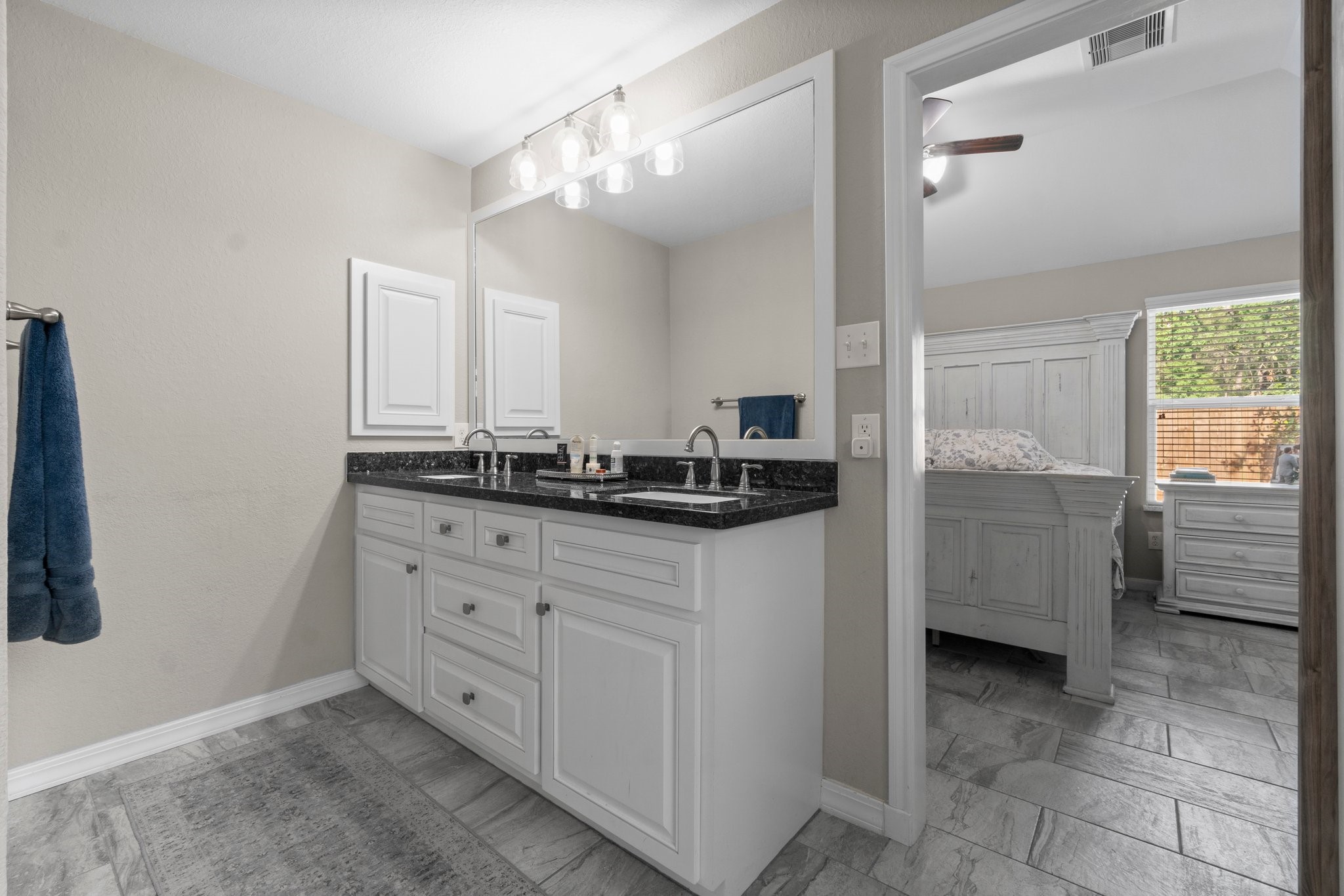 28987 Birch Green Way Spring, TX 77386 - Photo 19 of 32 a bathroom with a granite countertop sink a mirror and a shower