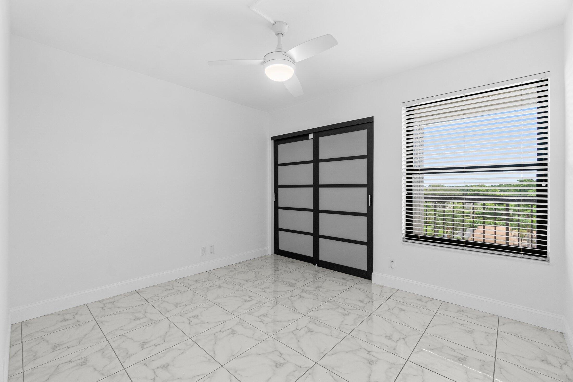 6562 Boca Del Mar Drive, Unit 527 Boca Raton, FL 33433 - Photo 20 of 38 an empty room with windows and fan