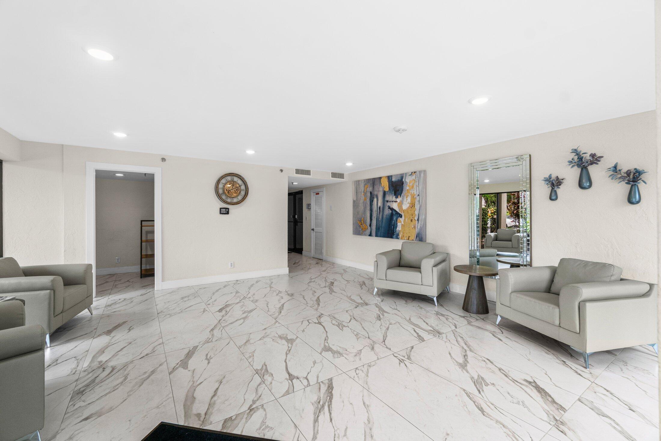 6562 Boca Del Mar Drive, Unit 527 Boca Raton, FL 33433 - Photo 32 of 38 a living room with furniture and a rug