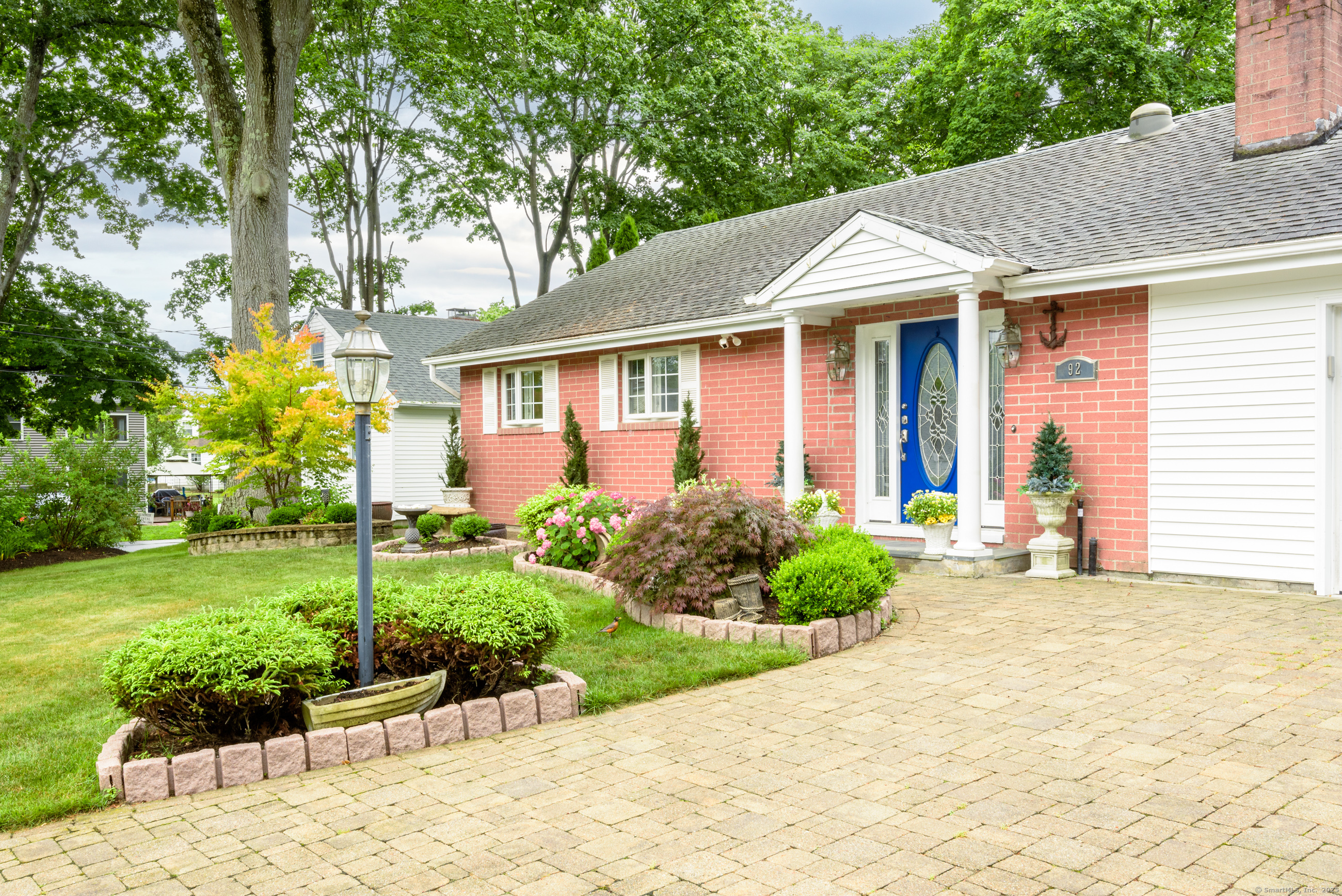 92 Grove Beach Road South Westbrook, CT 06498 - Photo 1 of 29 a front view of a house with a garden and plants