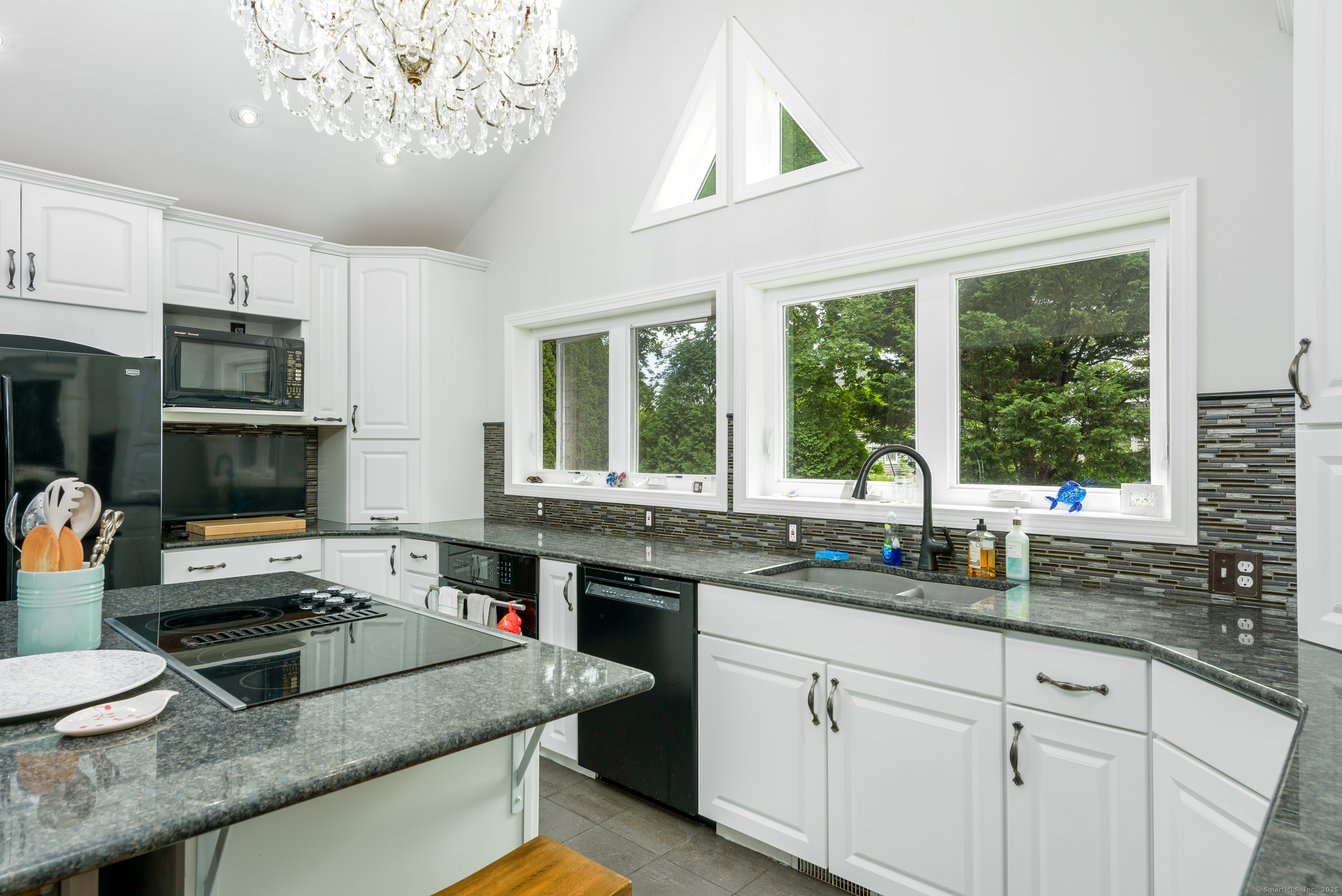 92 Grove Beach Road South Westbrook, CT 06498 - Photo 11 of 29 a kitchen with stainless steel appliances granite countertop a sink and a stove