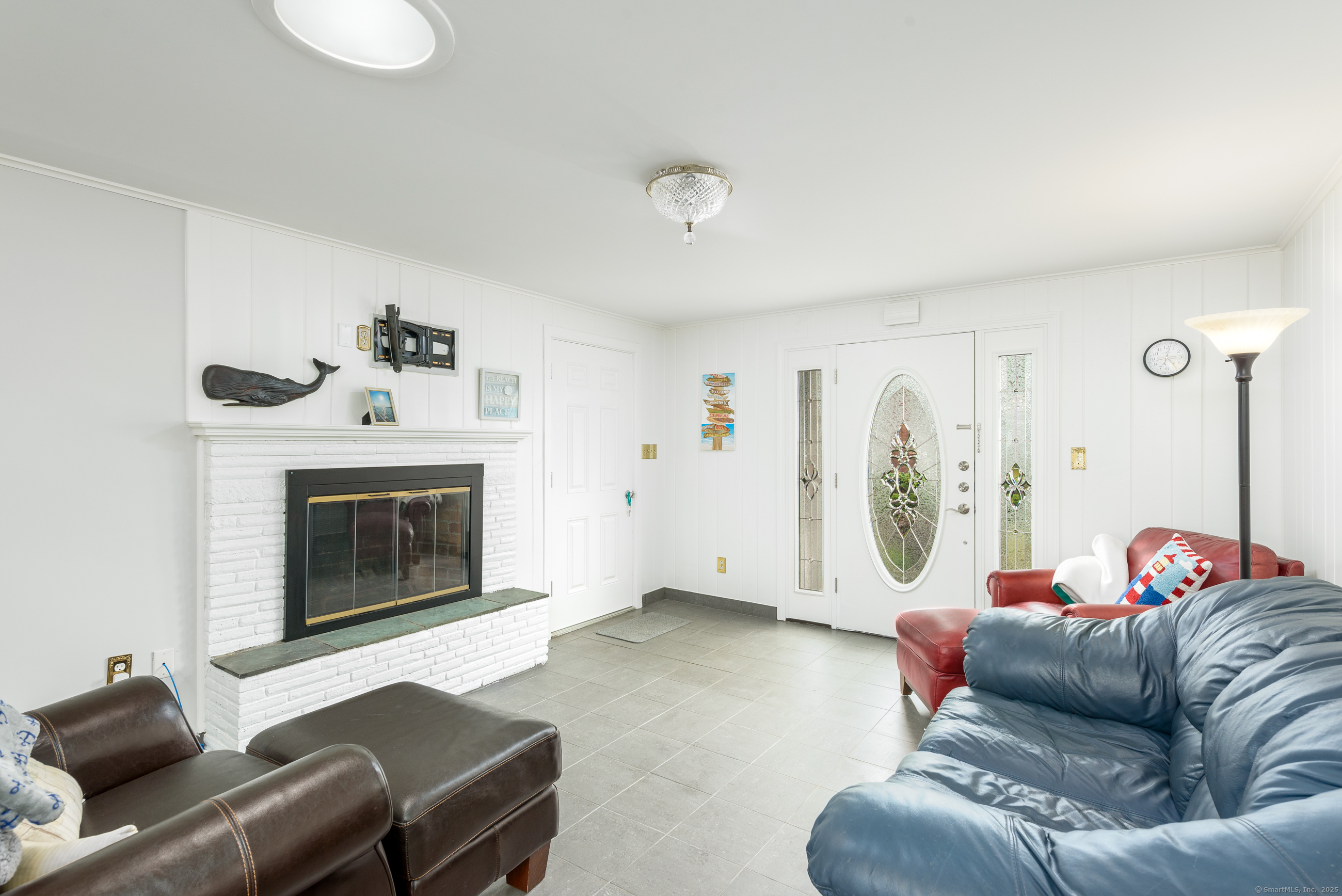 92 Grove Beach Road South Westbrook, CT 06498 - Photo 13 of 29 a living room with furniture and a fireplace