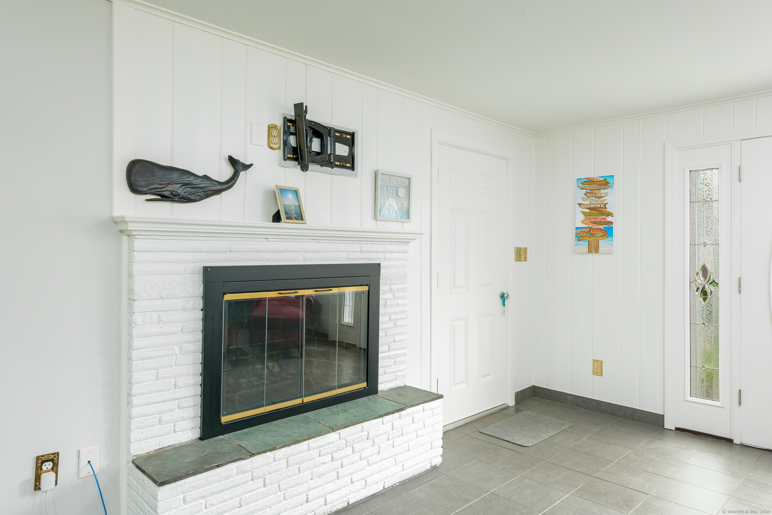 92 Grove Beach Road South Westbrook, CT 06498 - Photo 14 of 29 a living room with furniture and a fireplace