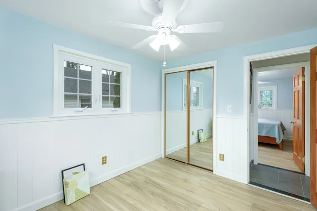 wooden floor in an empty room with a window