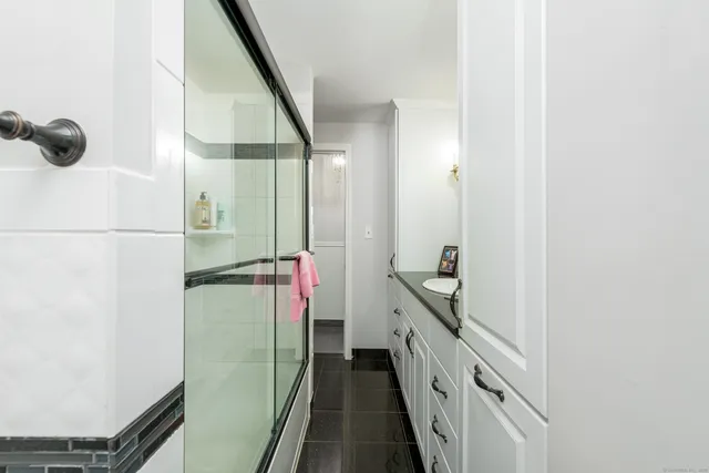 a bathroom with a light fixture a sink and a mirror
