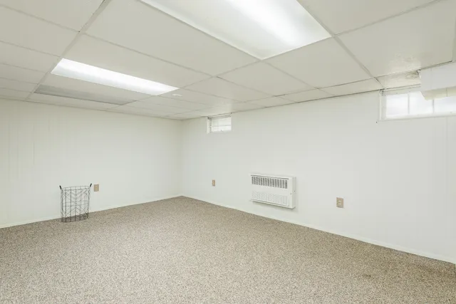 a bathroom with a granite countertop toilet sink and mirror