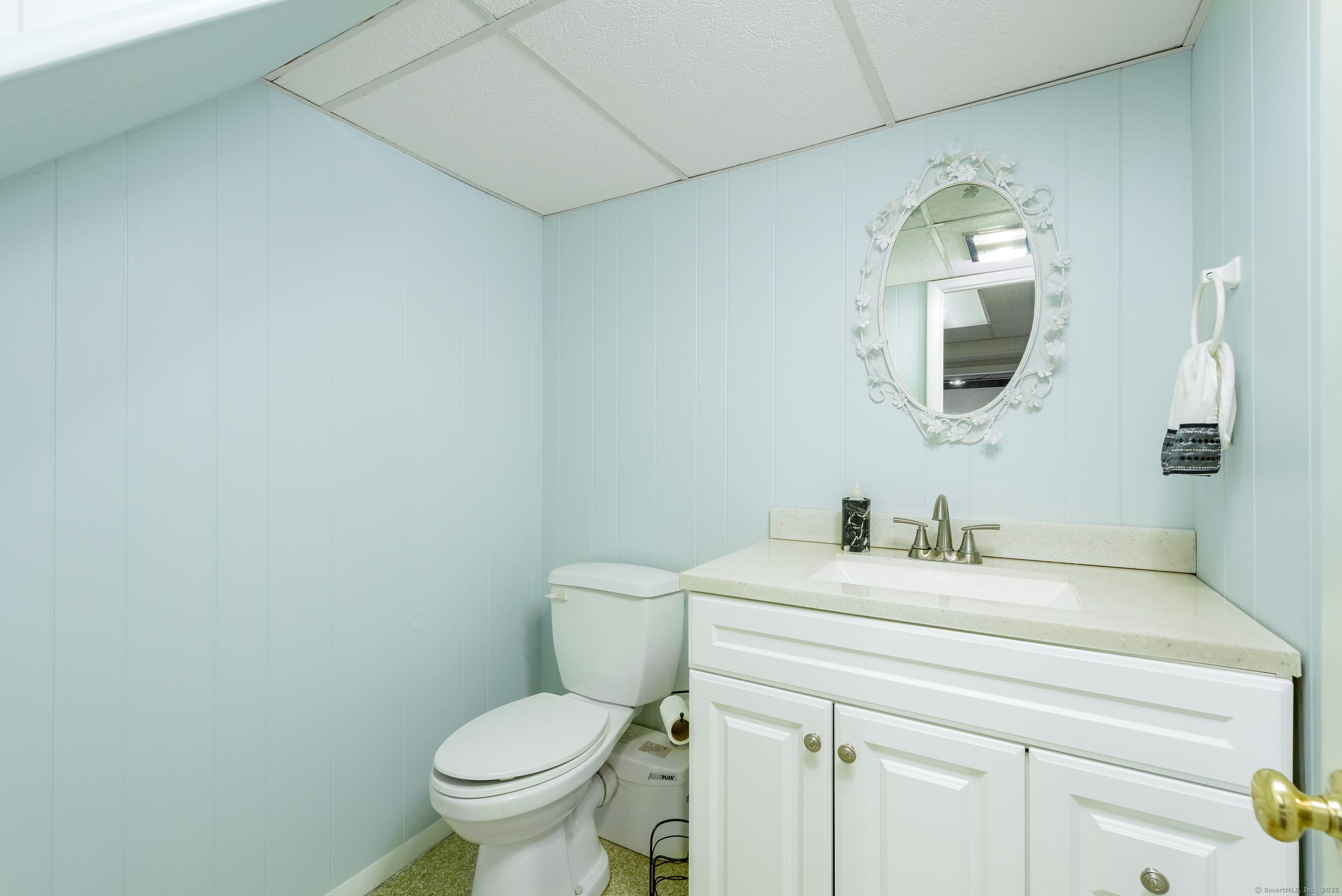 92 Grove Beach Road South Westbrook, CT 06498 - Photo 27 of 29 a bathroom with a granite countertop toilet sink and mirror