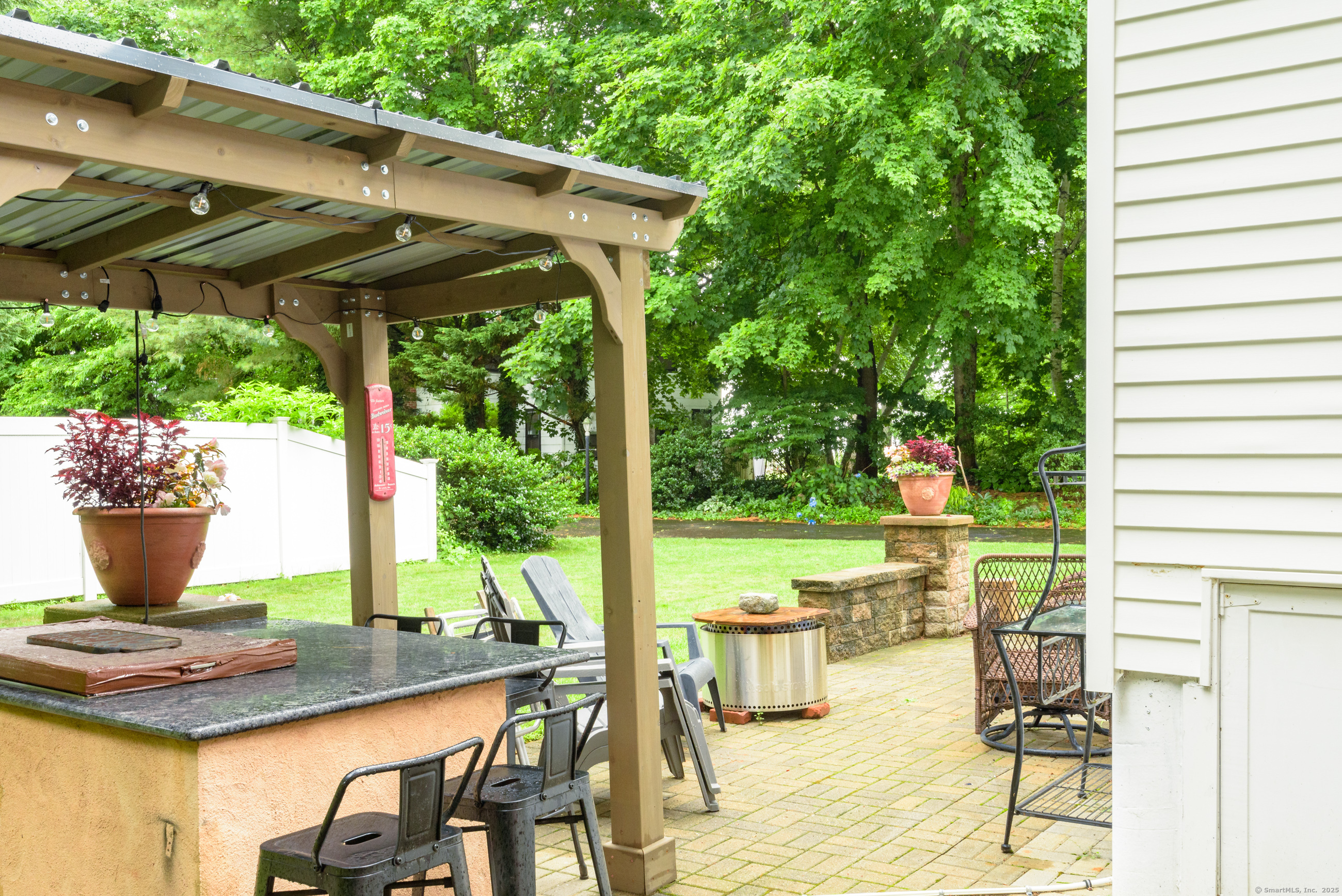 92 Grove Beach Road South Westbrook, CT 06498 - Photo 3 of 29 a view of a patio with table and chairs potted plants and palm trees