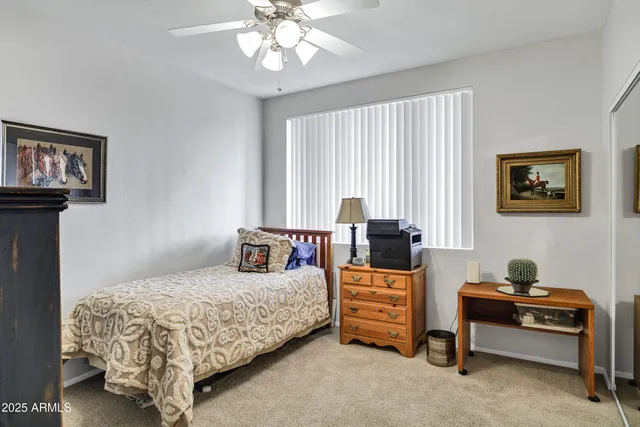 a bedroom with bed and a window