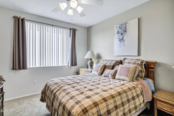 a bathroom with a granite countertop sink a toilet and a mirror