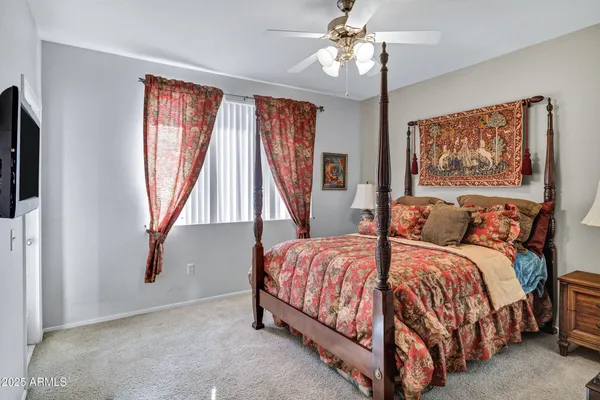 a bedroom with a bed and dresser