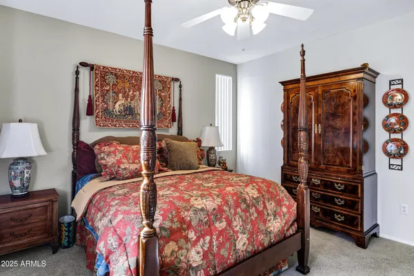 a bedroom with a bed and a flat tv screen