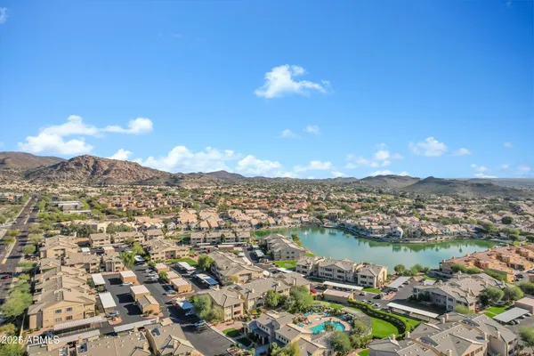 an aerial view of residential houses with outdoor space and river