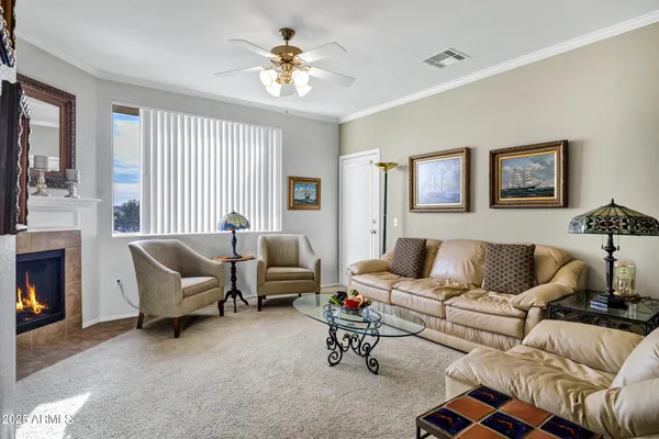 a living room with furniture a flat screen tv and a fireplace