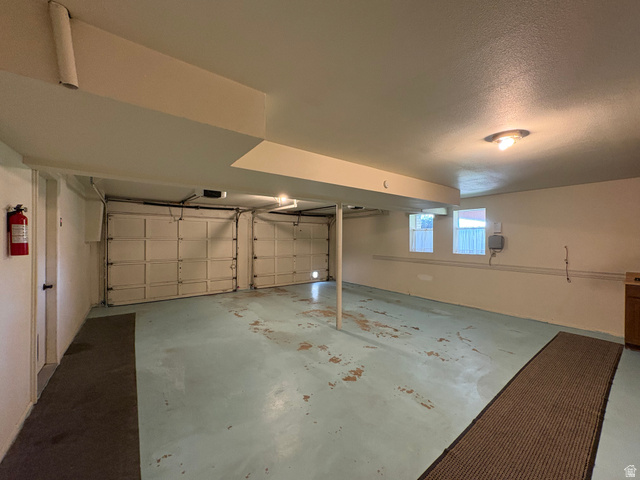595 Meadowlark Road Orem, UT 84097 - Photo 67 of 87 Spacious two-car garage with overhead doors, painted concrete flooring, and multiple windows providing natural light