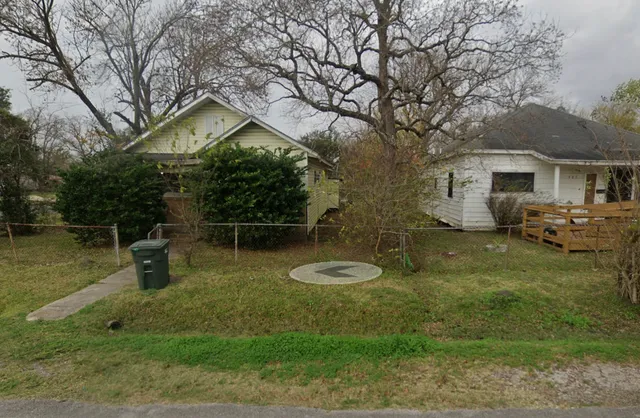 a backyard of a house with barbeque oven table and chairs