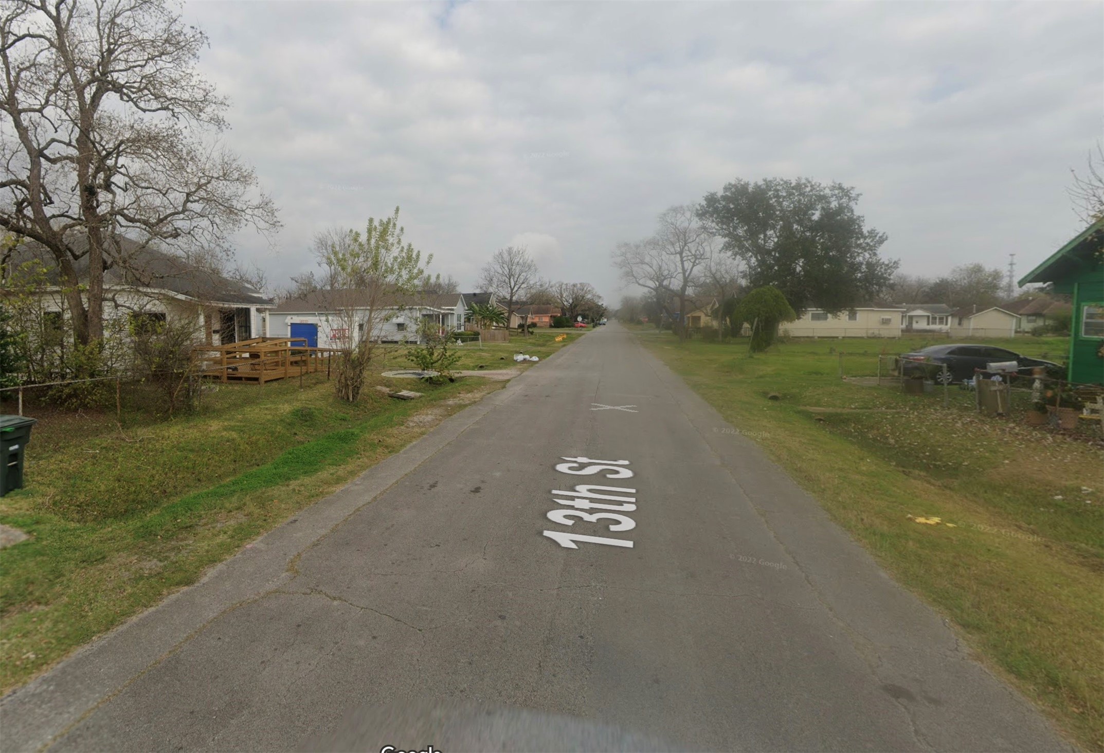 801 13th Street Port Arthur, TX 77640 - Photo 5 of 7 a view of a street with houses on both side of it