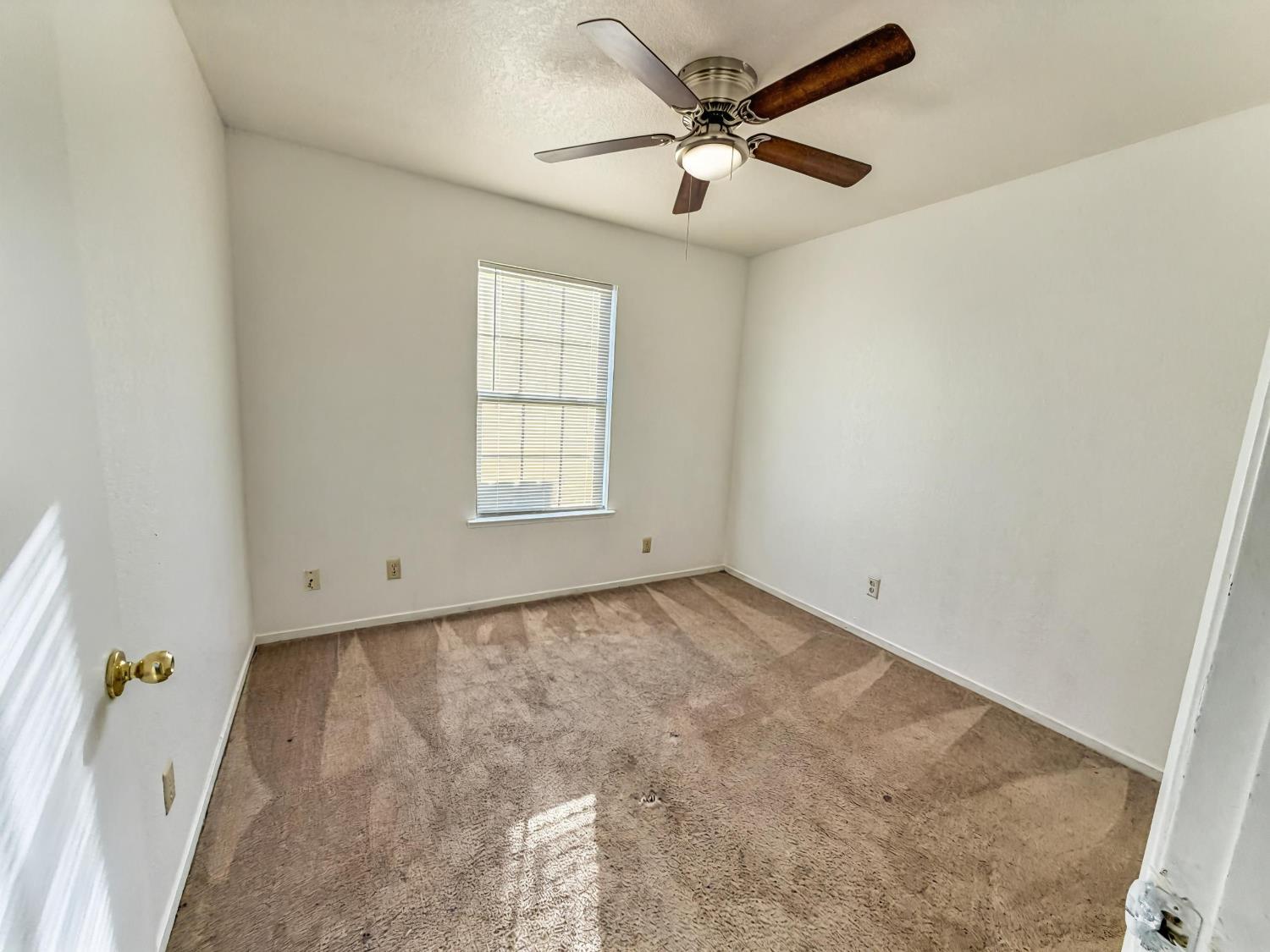 1405 East Cypress Avenue, Unit 137 Reedley, CA 93654 - Photo 9 of 15 an empty room with windows and fan