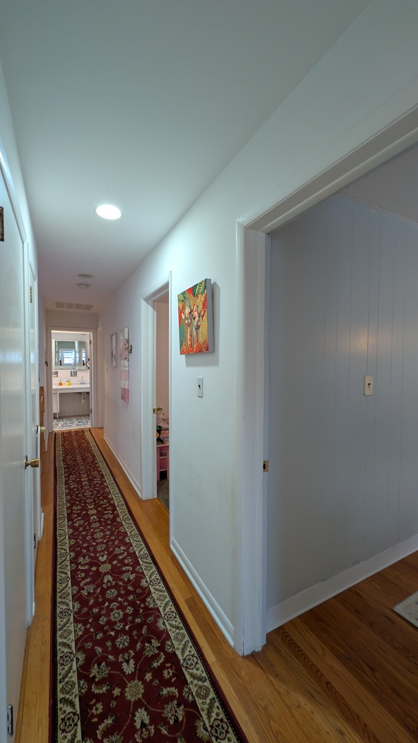 232 Kilpatrick Avenue Wilmette, IL 60091 - Photo 25 of 41 a view of a hallway with wooden floor and closet