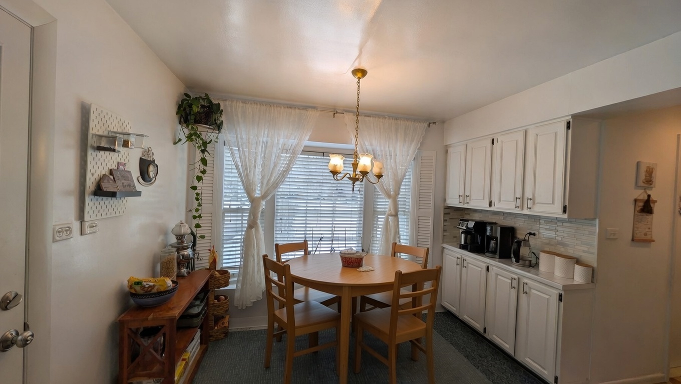 232 Kilpatrick Avenue Wilmette, IL 60091 - Photo 8 of 41 a kitchen with refrigerator a table and chairs in it