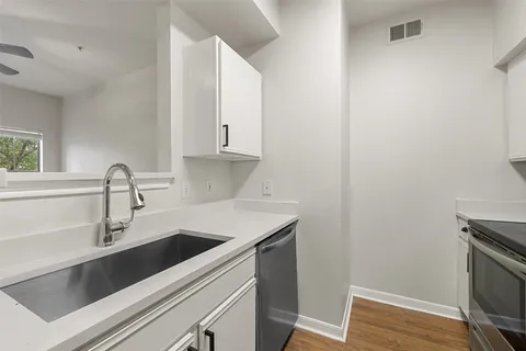 a view of a kitchen with sink and washing machine