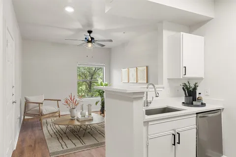 a kitchen with a sink cabinets and window